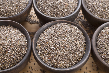 Organic chia seeds in wooden bowls - Salvia hispanica