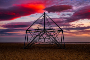 playground on the beach at sunset