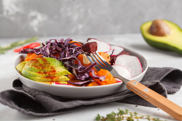 Bright vegetarian salad of baked beets, sweet potato and avocado. Healthy vegan food concept. Copy space, gray background