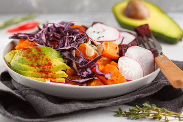 Bright vegetarian salad of baked beets, sweet potato and avocado. Healthy vegan food concept. Macro