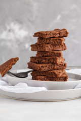A stack of slices of healthy vegan brownies. Healthy dietary vegan dessert concept.