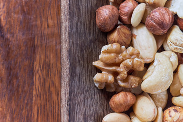 Mixed nuts including hazelnuts, walnuts, blanched almonds and cashews. Top view with copy space