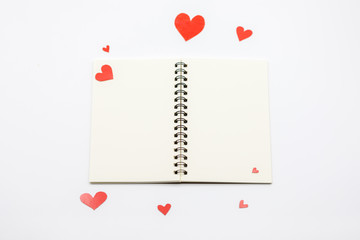 Many Paper red heart and Blank notebook with White Pastel plastic texture background. Valentine concept. Minimal concept