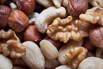 Mixed nuts including hazelnuts, walnuts, blanched almonds and cashews. Top view