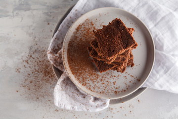 A stack of slices of healthy vegan brownies. Healthy dietary vegan dessert concept. Top view, copy space.
