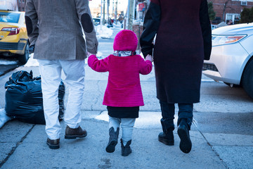 Child holding hands with parents