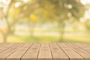 Naklejka na ściany i meble Empty wood table top on nature green blurred background at garden,space for montage show products