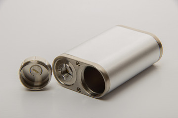 Dismantled parts of the electronic cigarette black and steel colors on a background