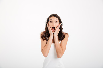 Portrait of an amuzed girl dressed in tank-top screaming