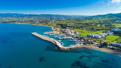 Aerial bird's eye view of Latchi port,Akamas peninsula,Polis Chrysochous,Paphos,Cyprus. The Latsi harbour with boats and yachts, fish restaurant, promenade, beach tourist area and mountains from above