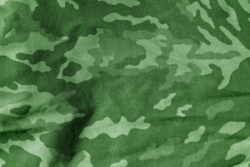 Military uniform pattern with blur effect in green tone.
