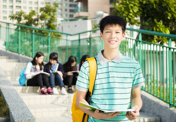 smiling boy Teenage Students standing  at campus