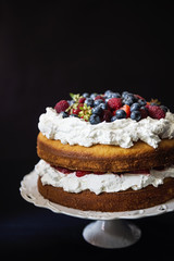 Beautiful, fruit naked cake on a dark tablecloth 