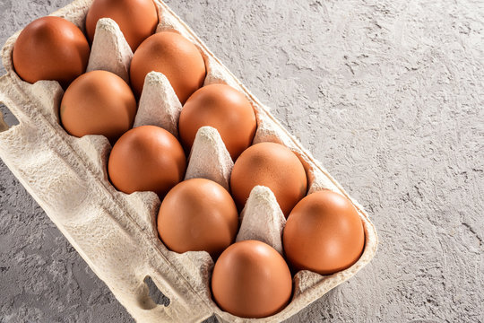 Farm raw fresh egg in pack on gray table scrambled eggs omelet fried egg