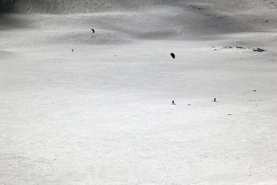 Parachute skiing in the snow covered landscape and mountains in the alps switzerland
