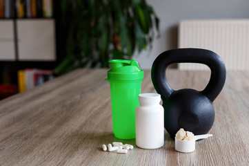 Sport nutrition with kettlebell on living room table