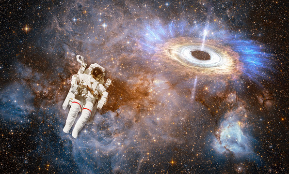 Astronaut in outer space against colorful storm galaxy. (Elements of this image furnished by NASA)