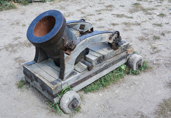 A mortar is a device that fires projectiles at low velocities and short ranges. Old rusty mortar or...