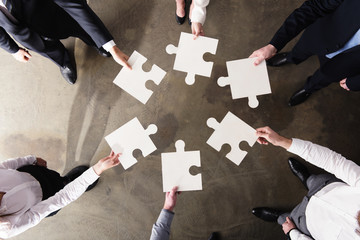 Teamwork of partners. Concept of integration and startup with puzzle pieces