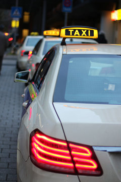 taxis waiting in a row, at dusk