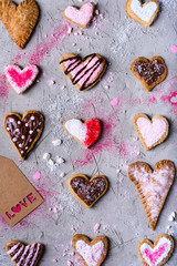 top view of various heart shaped cookies with love tag on grey cracked surface