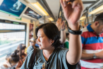 Fototapeta na wymiar Asian woman travel on skytrain train in city