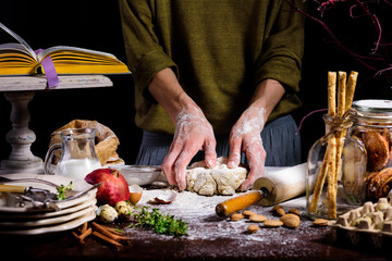 partial view of person preparing dough at table with ingredients