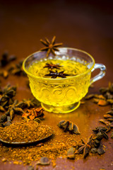 Illicium verum,star anise seeds in a glass bowl.its powder and its tea on wooden surface.