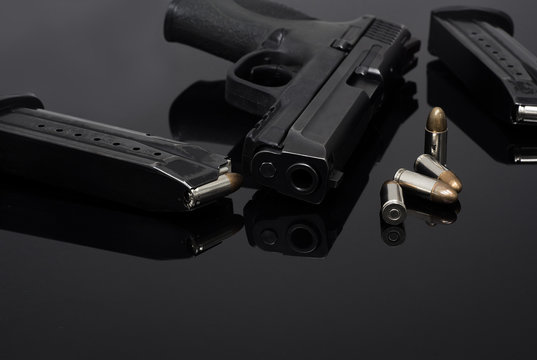 9mm Pistol gun with ammunition, Bullets and magazine on black background. Gun isolated.