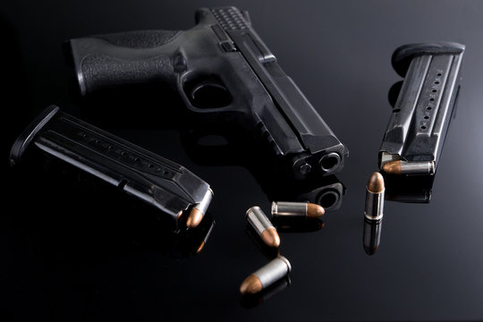 9mm Pistol gun with ammunition, Bullets and magazine on black background. Gun isolated.