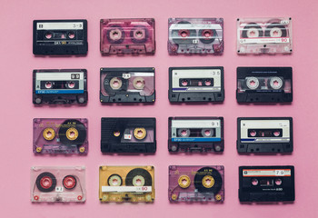Collection Of Retro Audio Tapes In Row  On Lilac Background. Retro Technology Music Concept