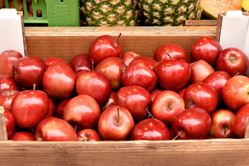 Red apples in a box. Apples are sold on the market.
