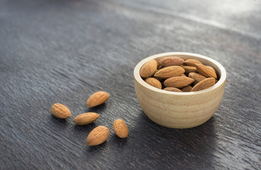 Almond seeds in wooden bowl.