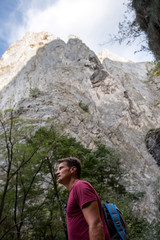 Naklejka na ściany i meble Adult hiking man in the rocky area, famous for climbing, in Romania