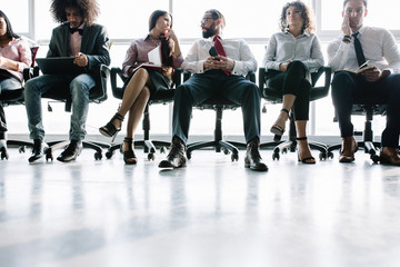 Six skilled managers having a little rest n comfortable chairs. Office concept.