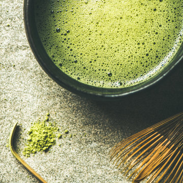 Flat-lay of freshly brewed Japanese matcha tea in Chasen bowl, top view, square crop