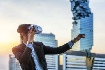 businessman with VR virtual gear for simulate business plan stand at outdoor