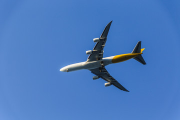 Commercial Airplane on Blue From Below