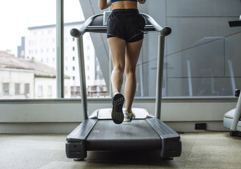 Woman Running at Gym