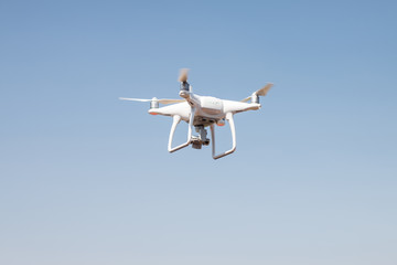drone quadcopter hover on sky background