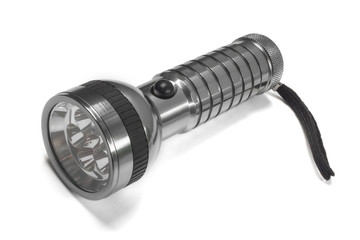 Metal flashlight isolated on white background.