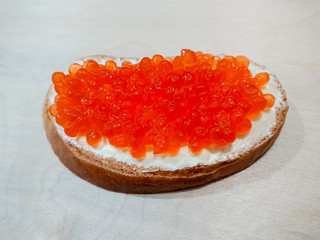 Sandwich with red caviar. White bread with butter. Seafood delicacies.