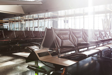 modern airport terminal with black leather seats at sunset.