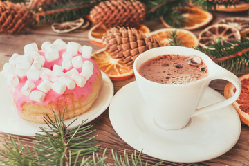 Coffee mood and donut with marshmallows while decorating home for Christmas time. Vintage colors and warm atmosphere