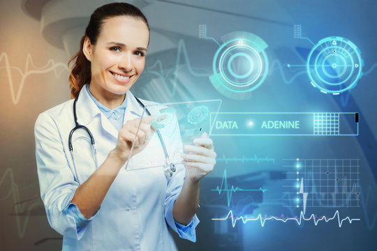 Futuristic device. Cheerful young professional doctor smiling and looking happy while holding an amazing futuristic transparent gadget in her hands