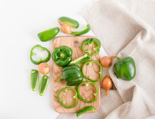 Green bell pepper,onion on the cutting board.top view