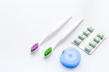 Tools for oral cavity hygiene. Gum, brushes, floss on white background copy space