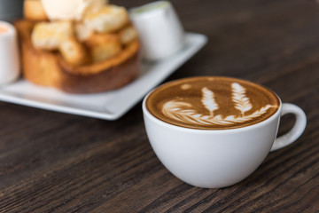 Hot coffee latte art cup  on wooden table