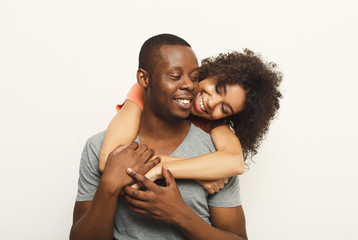 Black couple hugging and posing at white background