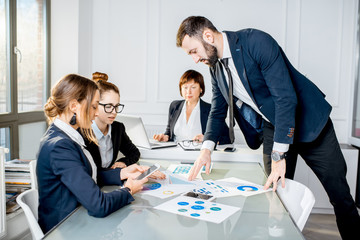 Business people working with charts and documents3 at the table during the conference in the office